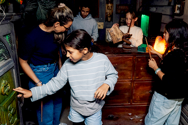 Kinder suchen nach Hinweisen im Exit Room